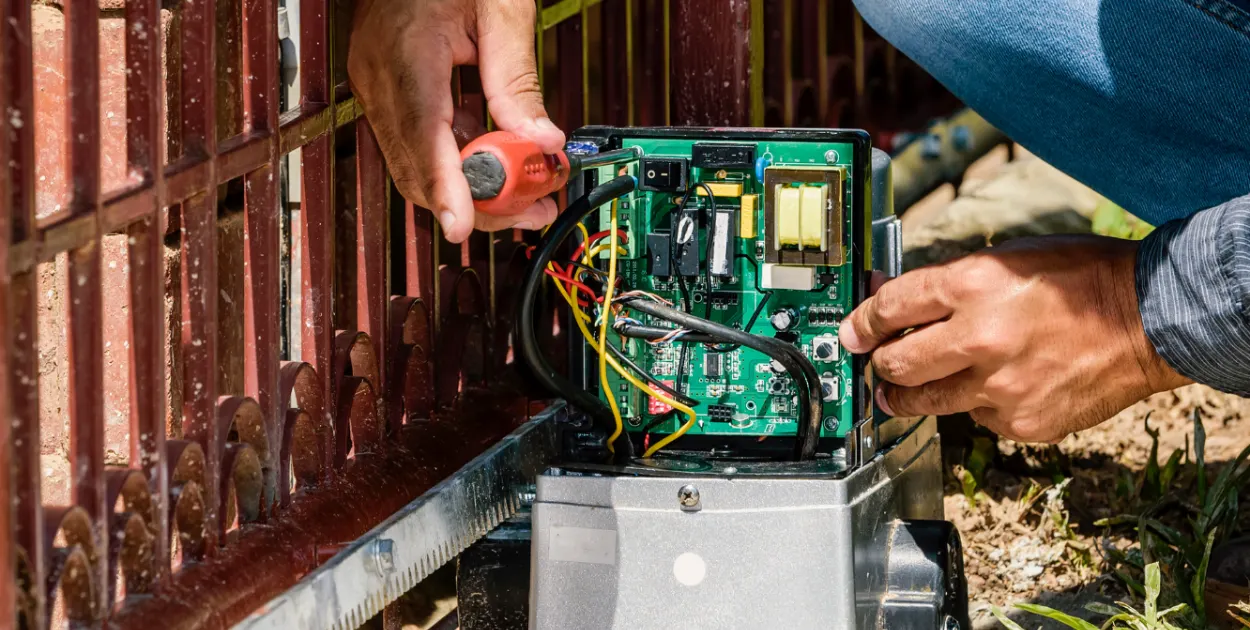 Especialista realizando assistência técnica e conserto de motor de portão automático